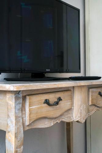 a television on top of a wooden console table at Feniks Agro&Spa Adults Only in Świnoujście