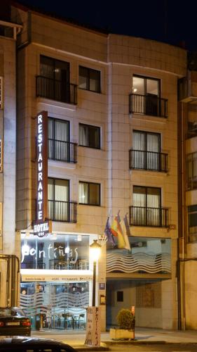 a hotel building with a sign in front of it at Hotel Restaurante Pontiñas in Lalín