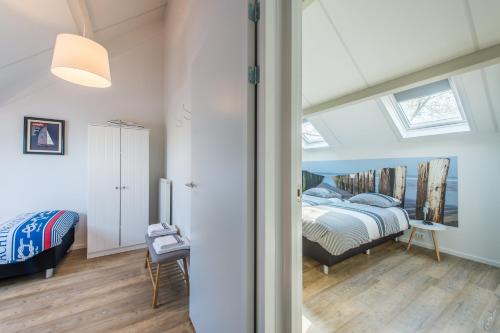 a bedroom with a bed and a window at Hansa watersport & recreatie in Wilhelminadorp