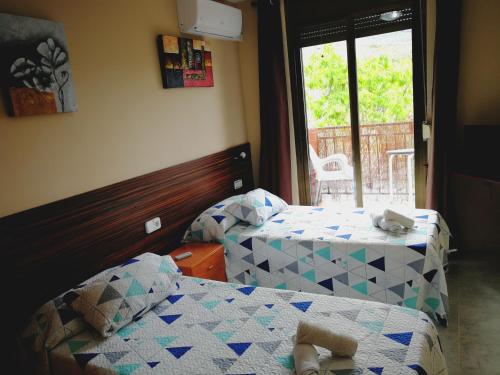 Ένα ή περισσότερα κρεβάτια σε δωμάτιο στο Hostal Escarla