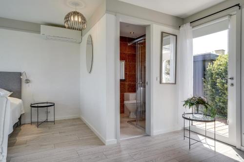 a hallway with a bathroom with a toilet and glass tables at Fjordhuset in Broager