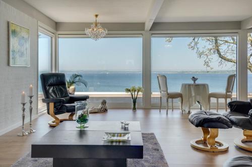 a living room with a view of the ocean at Fjordhuset in Broager