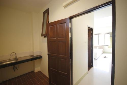 a room with a door and a sink and a bathroom at Buathong Place in Lamai