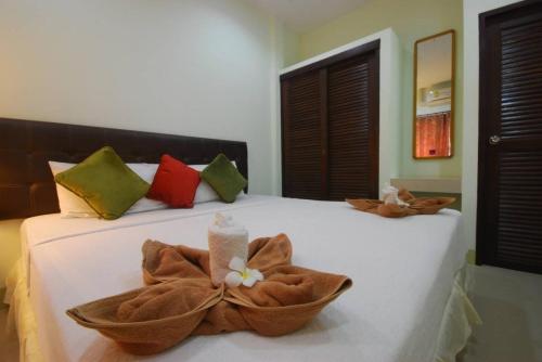 a bedroom with a bed with two towels on it at Buathong Place in Lamai