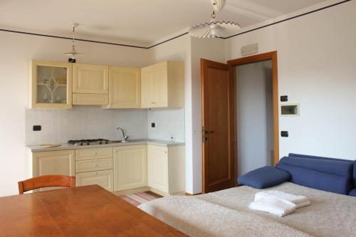 a kitchen with a table and a blue couch at Ghisolana Agriturismo al Capitello in Asolo