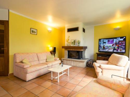 a living room with two couches and a fireplace at Colourful Holiday Home in Noves with Swimming Pool in Noves