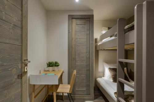 a small room with a desk and bunk beds at Annapurna by Alpine Resorts in Les Gets