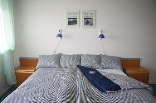 a bed with two lights on top of it at Heltermaa Hostel in Heltermaa