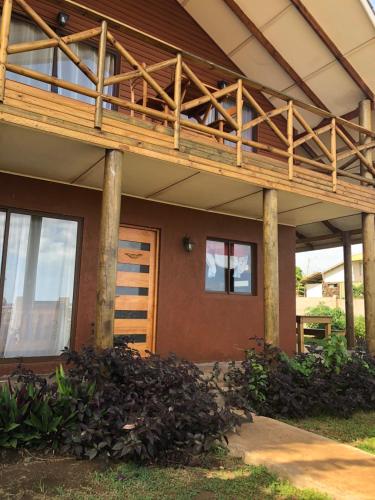 a house with a deck on top of it at Cabañas Anavai Rapa Nui in Hanga Roa