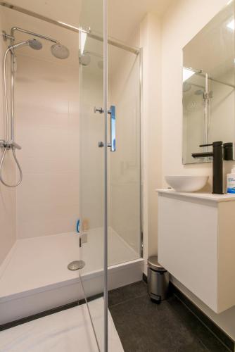 a bathroom with a shower and a sink at Seaview Zeebrugge in Zeebrugge