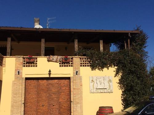 a house with a garage with a sign on it at Masseria del Vino in Loreto Aprutino
