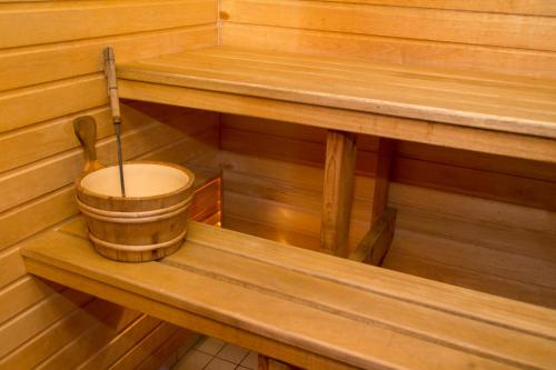 a inside of a wooden sauna with a bucket at Heltermaa Hotel in Heltermaa
