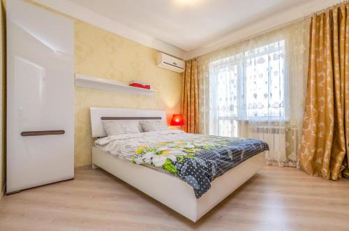 a small bedroom with a bed and a window at ARTAL Apartment on Obolonskyi Avenue 16a in Kyiv