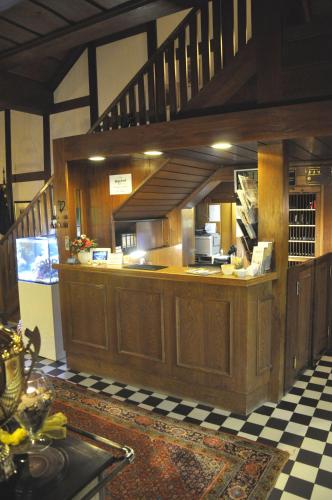 a large kitchen with wooden cabinets and a staircase at Jägerhof in Hannover