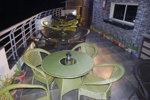 a row of tables and chairs on a balcony at Cloud 7 in Nainital