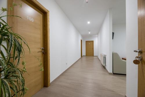 a corridor of an office building with a wooden door at A Chousa in Arzúa