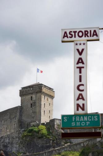 a building on top of a mountain with a sign at The Originals City, Hôtel Astoria Vatican, Lourdes in Lourdes