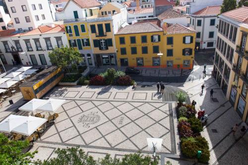 an overhead view of a courtyard in a city with buildings at Apartamentos Praça Amarela by Heart of Funchal in Funchal