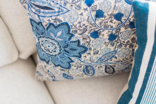 a blue and white pillow sitting on top of a couch at Apartamentos Praça Amarela by Heart of Funchal in Funchal