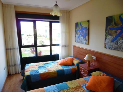 A bed or beds in a room at Playa de Altar Barreiros