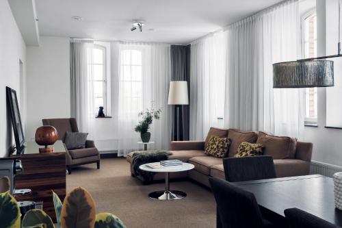 a living room with a couch and a table at Elite Hotel Marina Tower, Spa & Resort in Stockholm
