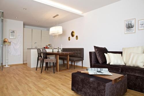a living room with a couch and a table at Apart Hotel Legendär in Steindorf am Ossiacher See