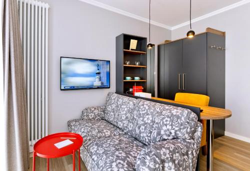 a living room with a couch and a table at Logierhaus RheintorEins in Rees