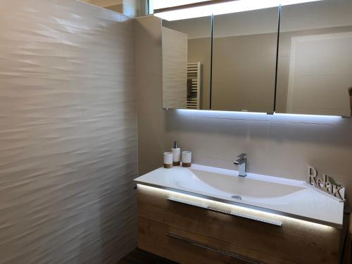 a bathroom with a sink and a mirror at Leiner Apartman in Hévíz
