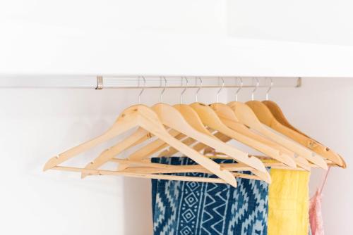 a closet organizer with wooden hangers and ties at Apartamentos Praça Amarela by Heart of Funchal in Funchal