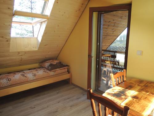 a dining room with a table and a window at Ptasi Folwark in Dolistowo