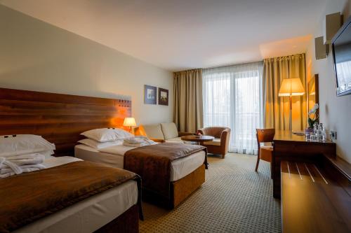 Giường trong phòng chung tại Hotel Trakošćan