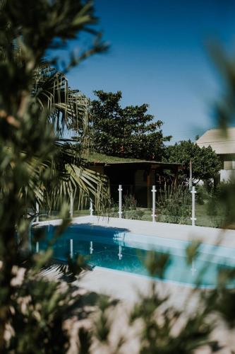 a swimming pool in front of a house at Pousada Santa Genoveva campeche in Florianópolis