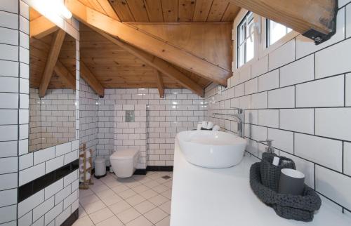 a bathroom with a sink and a toilet in it at Villa Status in Vouyiáton