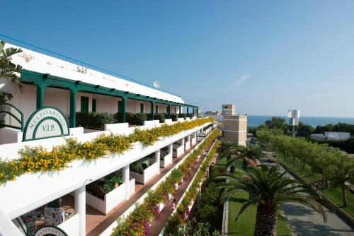 a building with flowers on the side of it at Corvino Resort in Monopoli