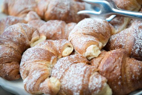 a plate of pastries with powdered sugar on them at Corvino Resort in Monopoli