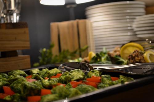 a tray of food with vegetables on a table at Rezydencja NOVA na Gubałówce in Zakopane