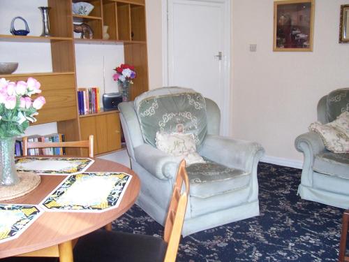 a living room with two chairs and a table at The Tops Self Catering in Leeds