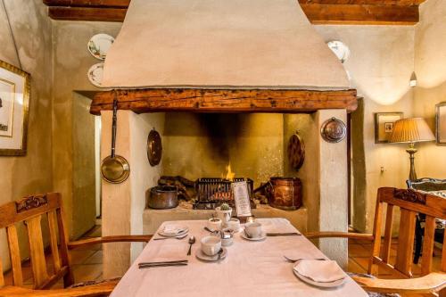 a dining room with a table and a fireplace at Lemoenkloof Boutique Hotel in Paarl