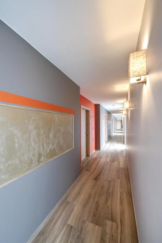 an empty hallway with wood floors and a painting on the wall at Au fil de l'eau in Seneffe