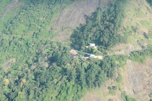 an aerial view of a house on a mountain at Abad Copper Castle Resort in Munnar
