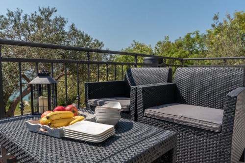 a tray of fruit on a table on a balcony at Rafael in Okrug Gornji