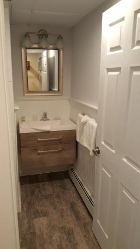 a bathroom with a sink and a mirror at Atlantic Motel in Point Pleasant Beach