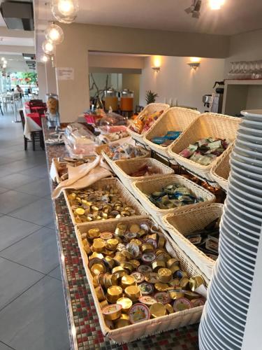 a display counter with several baskets filled with food at PFA Hotel La Darsena - Follonica in Puntone di Scarlino