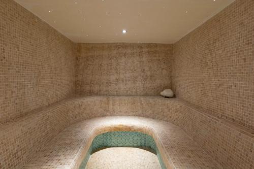 a bath tub in a room with a tiled wall at HSM Golden Playa in Playa de Palma