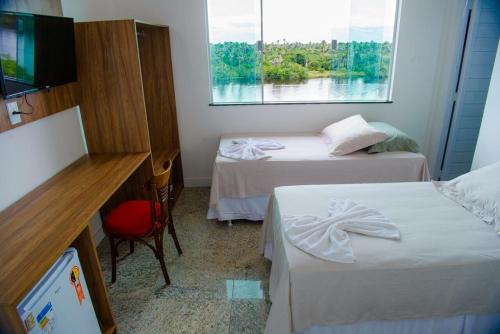 מיטה או מיטות בחדר ב-Pousada Barreirinhas