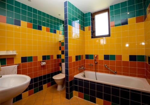 a bathroom with a tub and a toilet and a sink at Fontána Lipno in Černá v Pošumaví