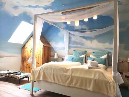 a bedroom with a canopy bed with a sky mural at Kunst Pension Frahm in Basthorst