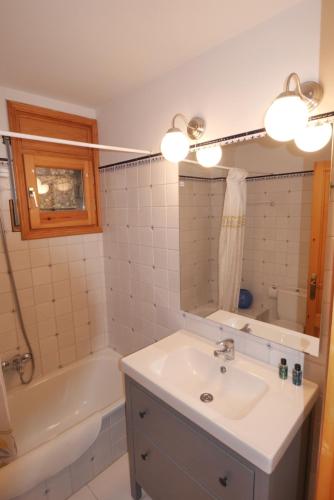 a bathroom with a sink and a bath tub at Cozy Apartment in Alp in Alp