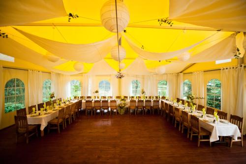 a large room with tables and chairs in it at Rancho Ślężański Młyn in Szczepanów