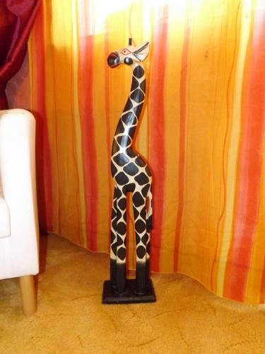 a statue of a giraffe standing on the floor at Haus Oberkassel in Bonn